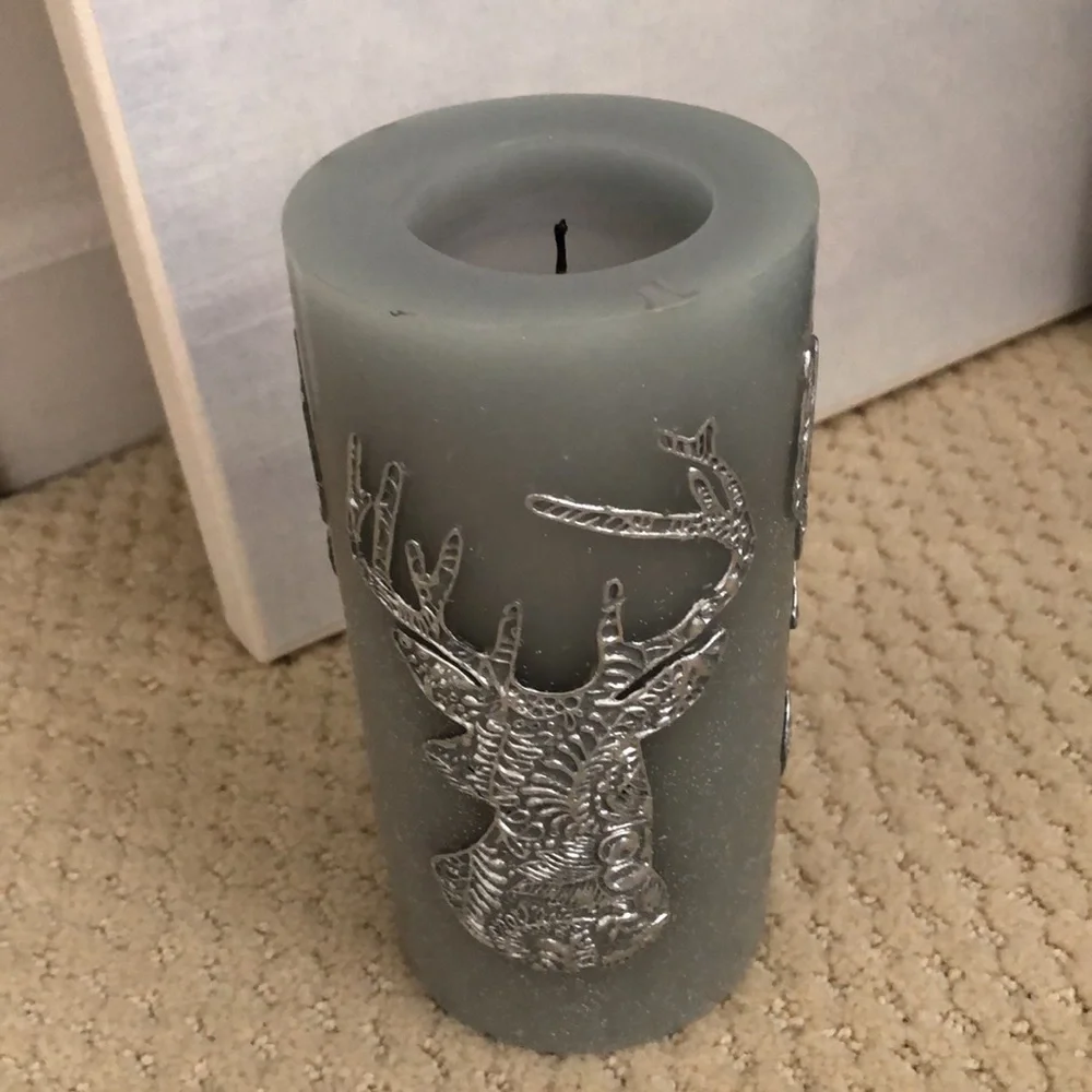 Pier 1 candle deer motif. Unused. Grey, blue, silver. 3” wide, 6” high